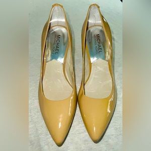 Womans Tan heeled Michael Kors dress shoes.